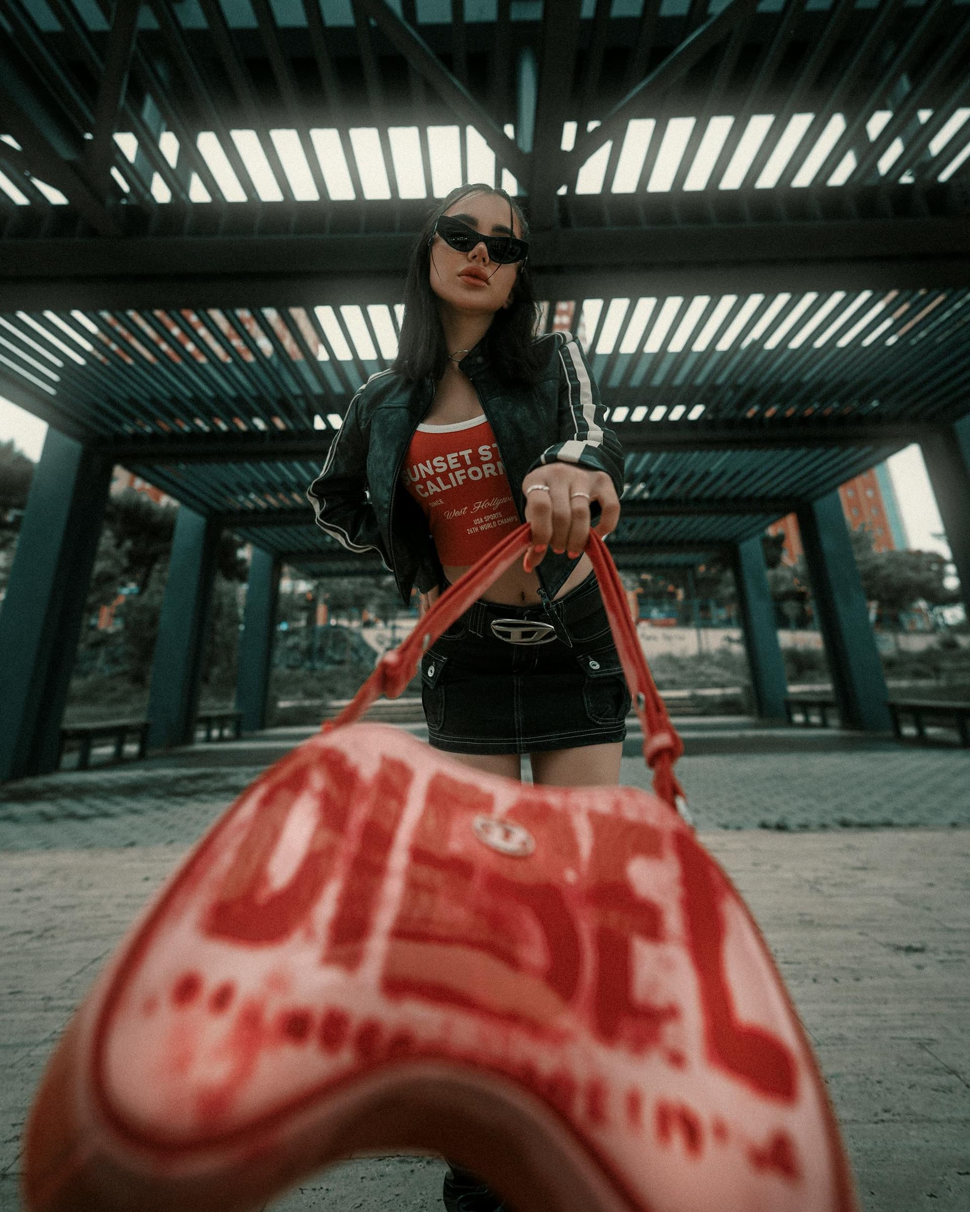 An example upload: a cropped leather jacket over a red graphic tank and a black denim mini skirt