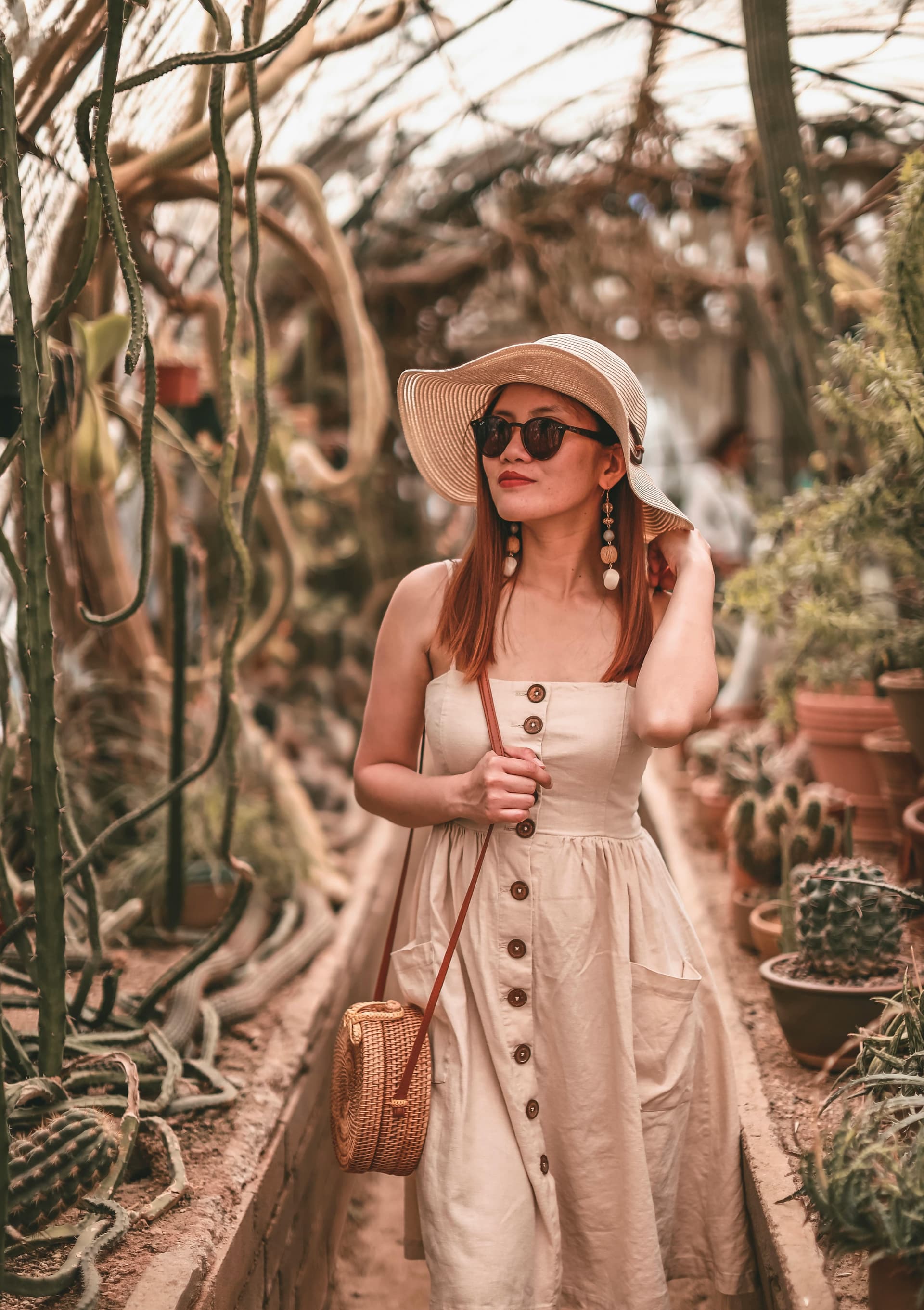A saved look: a linen button-front sundress with a straw hat and rattan bag