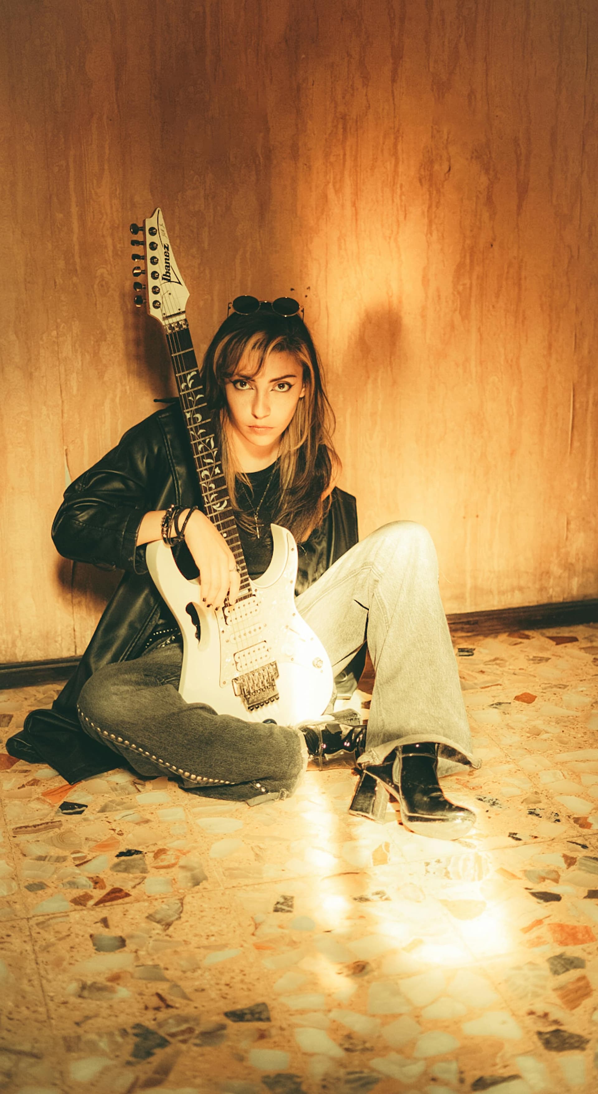 A saved look: a black leather jacket with faded jeans and heeled boots